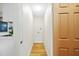Hallway view of a laundry room with wood floors and white walls, next to the kitchen at 1206 E Osborne Ave, Tampa, FL 33603