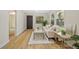 Bright living room featuring a white sofa, modern flooring, and natural light from multiple windows at 1206 E Osborne Ave, Tampa, FL 33603