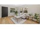 Bright living room featuring a white sofa, modern flooring, and natural light from multiple windows at 1206 E Osborne Ave, Tampa, FL 33603
