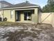 View of the backyard with a sliding glass door leading to the patio at 15421 Shoal Haven Pl, Ruskin, FL 33573