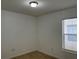 This bedroom showcases wood-look tile flooring and natural lighting at 15421 Shoal Haven Pl, Ruskin, FL 33573