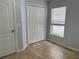 This bedroom features light blue walls, wood-look tile flooring, and natural light at 15421 Shoal Haven Pl, Ruskin, FL 33573