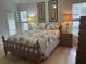 Bedroom features wood-look floors, natural light, and coordinated furnishings at 15421 Shoal Haven Pl, Ruskin, FL 33573