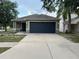 Charming single-story home featuring a two-car garage, well-maintained landscaping, and a welcoming entrance at 15421 Shoal Haven Pl, Ruskin, FL 33573