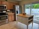 Functional kitchen with stainless steel appliances, center island and wood cabinets; perfect for cooking at 15421 Shoal Haven Pl, Ruskin, FL 33573