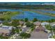 A lovely home nestled in a community lush with trees and greenery, with a serene lake creating a tranquil backdrop at 1701 Bonita Bluff Ct, Ruskin, FL 33570