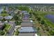 Aerial view of home in a residential area, featuring nearby ponds, streets and manicured lawns at 1701 Bonita Bluff Ct, Ruskin, FL 33570