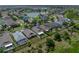 Expansive aerial view showcasing a well-maintained residential area with a picturesque lake in the background at 1701 Bonita Bluff Ct, Ruskin, FL 33570