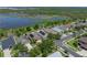 A high-angle view displays homes with solar panels, nestled in a green landscape close to a tranquil lake at 1701 Bonita Bluff Ct, Ruskin, FL 33570