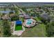 Aerial view showcasing the community pool, playground, and surrounding lush landscaping and lakes at 1701 Bonita Bluff Ct, Ruskin, FL 33570