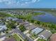 Aerial view of a community with a lake, showcasing a well-planned neighborhood and natural surroundings at 1701 Bonita Bluff Ct, Ruskin, FL 33570