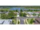 Aerial view of a single-Gathering home with solar panels on the roof, surrounded by lush landscaping and a serene lake at 1701 Bonita Bluff Ct, Ruskin, FL 33570
