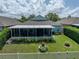Aerial view of backyard with screened lanai and lush landscaping at 1701 Bonita Bluff Ct, Ruskin, FL 33570