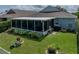 Backyard view showcasing screened-in lanai and manicured landscaping at 1701 Bonita Bluff Ct, Ruskin, FL 33570