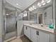 Bright bathroom featuring a double sink vanity, a walk-in shower, and modern fixtures at 1701 Bonita Bluff Ct, Ruskin, FL 33570