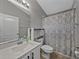 Clean bathroom with a modern vanity, toilet, and a patterned shower curtain at 1701 Bonita Bluff Ct, Ruskin, FL 33570