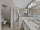 Bathroom featuring a double sink vanity, walk-in shower, and tile flooring at 1701 Bonita Bluff Ct, Ruskin, FL 33570