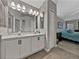 Bathroom featuring a double sink vanity and ensuite access to main bedroom at 1701 Bonita Bluff Ct, Ruskin, FL 33570