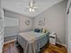 Comfortable bedroom with wood floors, a ceiling fan, and natural light from a window at 1701 Bonita Bluff Ct, Ruskin, FL 33570