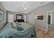 Well-lit main bedroom featuring a ceiling fan, wood floors, and ensuite bathroom at 1701 Bonita Bluff Ct, Ruskin, FL 33570