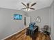 Gray painted bedroom featuring a ceiling fan, vinyl flooring, and mounted TV at 1701 Bonita Bluff Ct, Ruskin, FL 33570