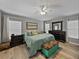 Spacious main bedroom featuring wood floors, neutral paint, and a large bed at 1701 Bonita Bluff Ct, Ruskin, FL 33570