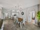 Open-concept dining room with a wooden table, white chairs, and views into the kitchen and other living spaces at 1701 Bonita Bluff Ct, Ruskin, FL 33570