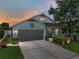 Charming single-story home featuring a two-car garage, covered porch, and manicured landscaping at 1701 Bonita Bluff Ct, Ruskin, FL 33570