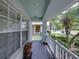 Cozy covered front porch with white railing, offering shade and a view of the well-kept neighborhood at 1701 Bonita Bluff Ct, Ruskin, FL 33570