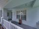 Inviting covered front porch features a unique wooden statue and coastal decorations at 1701 Bonita Bluff Ct, Ruskin, FL 33570