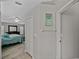 Hallway leads into a main bedroom featuring neutral paint and wood floors at 1701 Bonita Bluff Ct, Ruskin, FL 33570