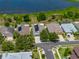 Aerial shot of a charming single-Gathering home with solar panels, well-manicured lawn, and proximity to a lake at 1701 Bonita Bluff Ct, Ruskin, FL 33570