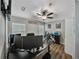 Functional home office with multiple monitors, modern desk, and hardwood floors at 1701 Bonita Bluff Ct, Ruskin, FL 33570