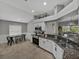 Well-equipped kitchen with stainless steel appliances, granite counters, and an open layout to the dining area at 1701 Bonita Bluff Ct, Ruskin, FL 33570