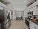 Bright kitchen featuring stainless steel appliances, a breakfast nook, and adjacent laundry room access at 1701 Bonita Bluff Ct, Ruskin, FL 33570