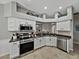 Stylish kitchen featuring stainless steel appliances, granite countertops, and a view to the dining area at 1701 Bonita Bluff Ct, Ruskin, FL 33570