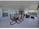 Covered lanai with a dining table and comfortable seating at 1701 Bonita Bluff Ct, Ruskin, FL 33570