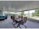 Screened lanai features a dining table, seating, and peaceful views at 1701 Bonita Bluff Ct, Ruskin, FL 33570