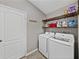 Functional laundry room equipped with modern washer, dryer, and ample shelving at 1701 Bonita Bluff Ct, Ruskin, FL 33570