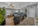Spacious living room with a large sectional sofa, hardwood floors, and bright natural light at 1701 Bonita Bluff Ct, Ruskin, FL 33570