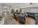 Open concept living room featuring a large sectional, hardwood floors, and contemporary decor at 1701 Bonita Bluff Ct, Ruskin, FL 33570