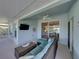 Comfortable cushioned seating area in enclosed porch with sliding glass doors and ceiling fan at 1701 Bonita Bluff Ct, Ruskin, FL 33570