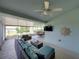 Enclosed porch with comfortable cushioned seating area and view of the dining table at 1701 Bonita Bluff Ct, Ruskin, FL 33570