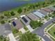 Aerial shot of a house with solar panels, a well-kept lawn, and a view of a nearby lake at 1701 Bonita Bluff Ct, Ruskin, FL 33570