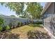 Landscaped backyard featuring a variety of plants and decorative elements with a glimpse of the screened-in porch at 1729 Arabian Ln, Palm Harbor, FL 34685