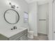 Stylish bathroom featuring a sleek vanity, modern lighting, and glass-enclosed shower at 1729 Arabian Ln, Palm Harbor, FL 34685