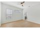 Light-filled bedroom with modern wood floors and an ensuite bathroom at 1729 Arabian Ln, Palm Harbor, FL 34685
