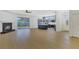 Open-concept layout featuring a modern kitchen that flows into a spacious living area with a fireplace and access to the backyard at 1729 Arabian Ln, Palm Harbor, FL 34685