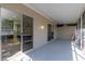 Enclosed porch with a view into the home's modern kitchen, providing a seamless indoor-outdoor living experience at 1729 Arabian Ln, Palm Harbor, FL 34685