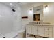 Clean bathroom with white subway tile shower, granite countertop vanity, and stylish light fixtures at 17631 Grove View Dr, Lutz, FL 33549
